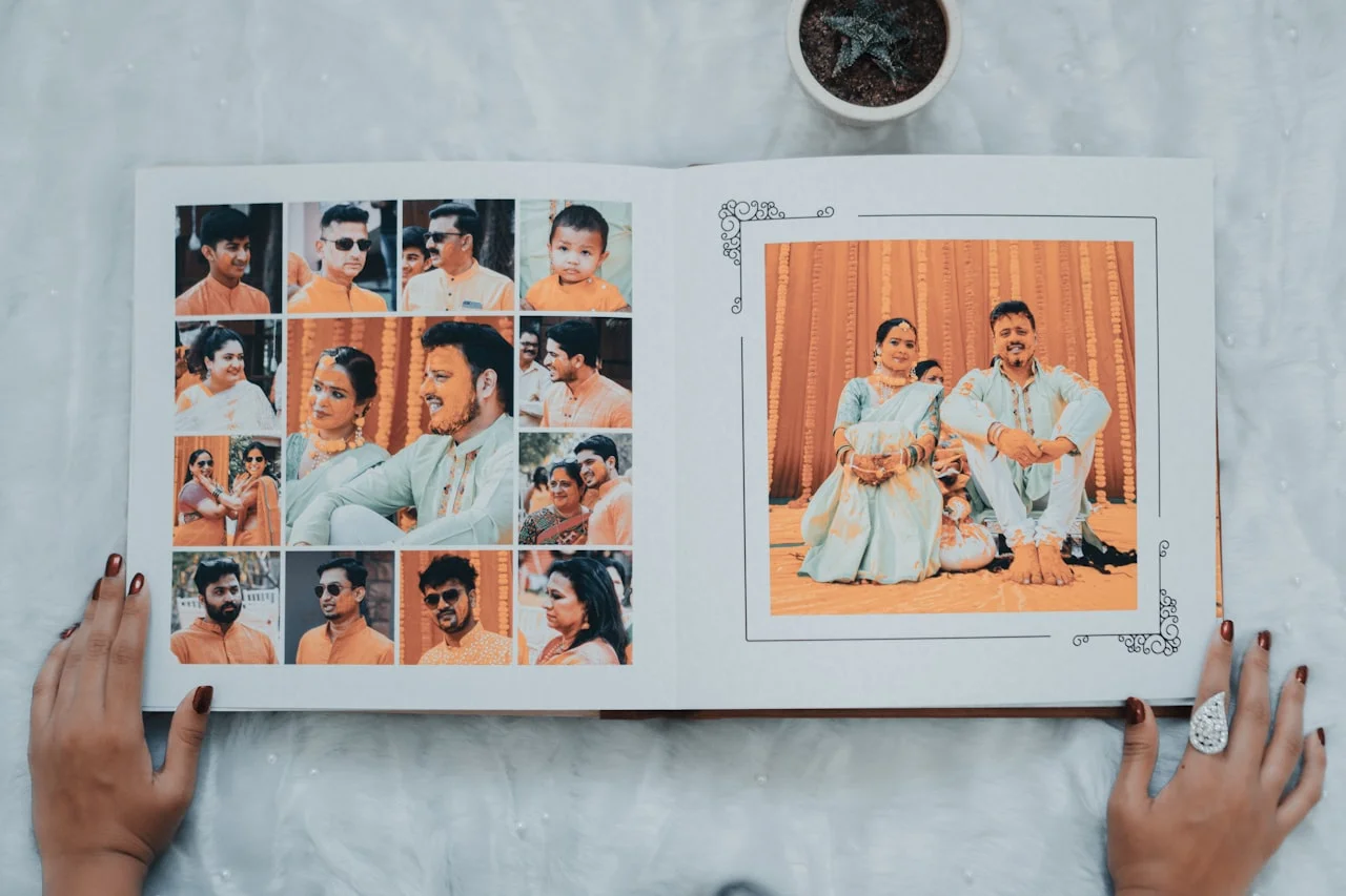 Ruky vkladajú vytlačené fotografie do klasického rodinného fotoalbumu